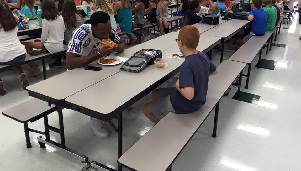 Florida State receiver Travis Rudolph eats lunch with autistic boy sitting by himself